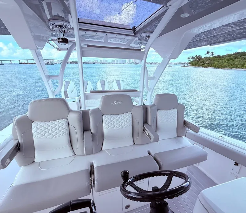 Slide: The Image of 2024 Scout 400 LXF boat interior with luxurious seating and ocean view. - 40