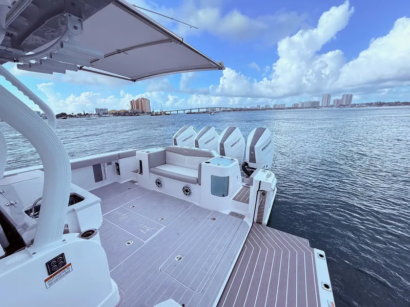 Slide: The Image of 2024 Scout 400 LXF boat with Mercury engines on a calm water backdrop. - 44