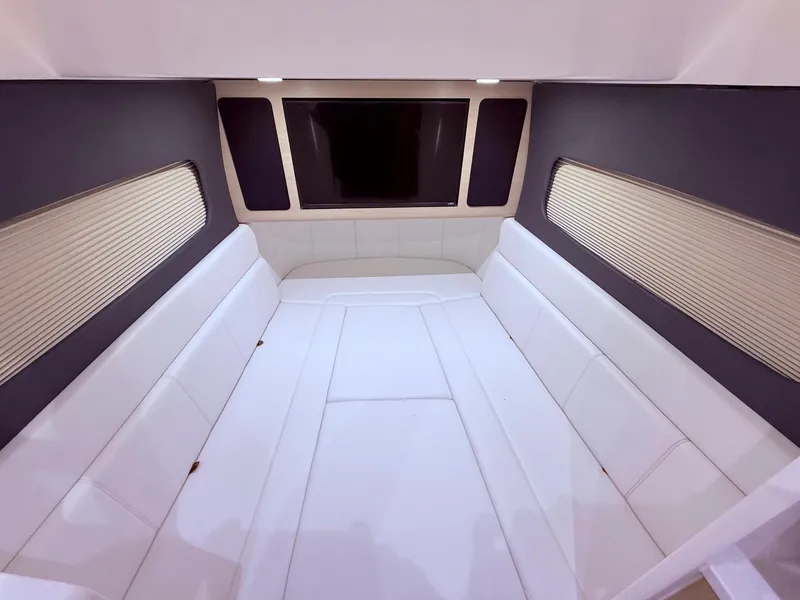 Slide: The Image of Luxurious interior cabin of 2024 Scout 400 LXF boat with white seating. - 48