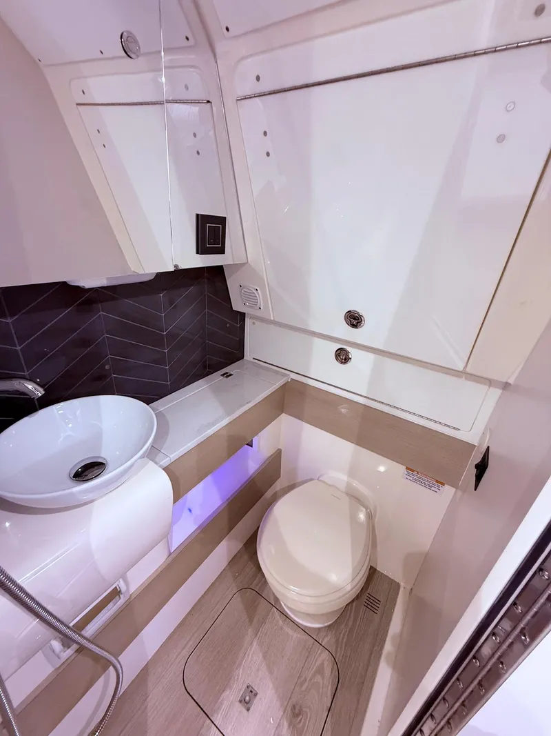 Slide: The Image of 2024 Scout 400 LXF boat bathroom with modern sink and toilet. - 53