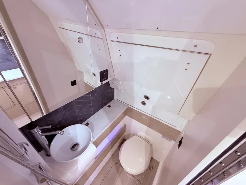 Slide: The Image of Luxurious bathroom interior of 2024 Scout 400 LXF boat, featuring modern sink and toilet. - 54