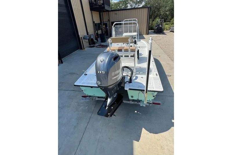 Slide: The Image of 2008 Shallow Sport 18SS boat with Yamaha 115 outboard motor, parked outdoors. - 10