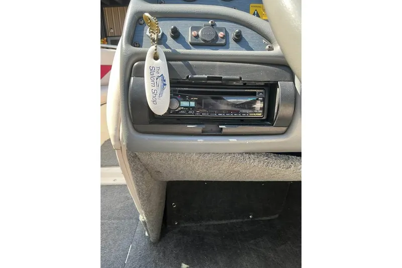 Slide: The Image of 2008 Shallow Sport 18SS boat dashboard with stereo system and keychain. - 18