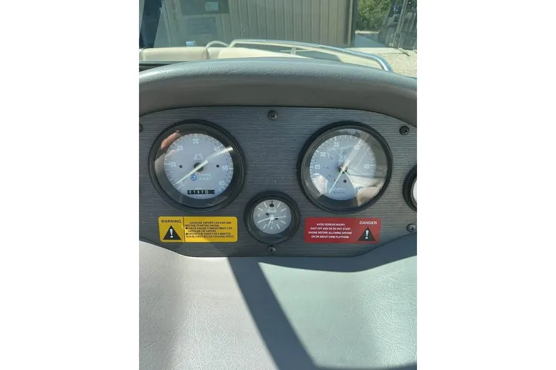 Slide: The Image of Dashboard of 2008 Shallow Sport 18SS boat with gauges and warning labels. - 19