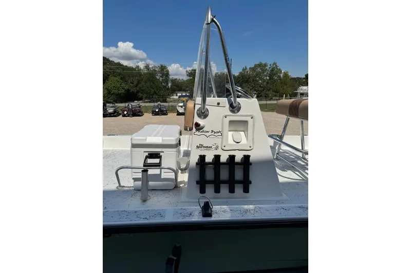 Slide: The Image of 2008 Shallow Sport 18SS boat console with seating and storage, outdoors under clear sky. - 7