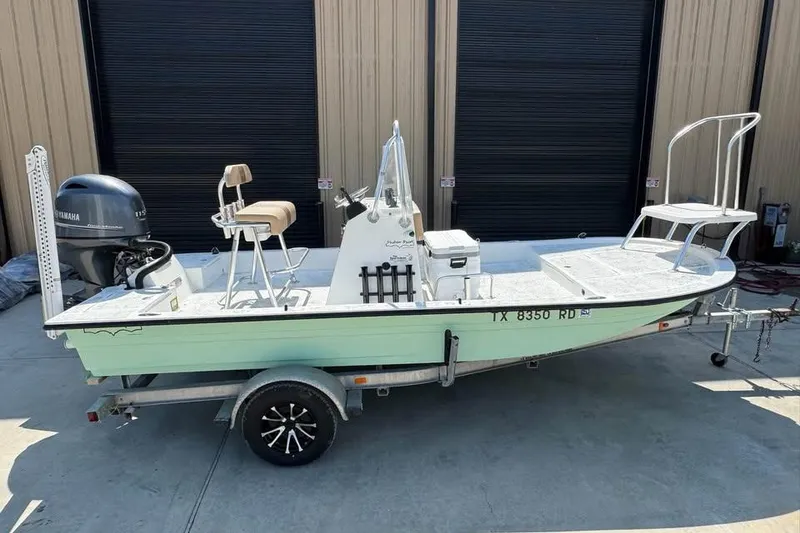 Slide: The Image of 2008 Shallow Sport 18SS boat on trailer, featuring Yamaha outboard motor. - 9