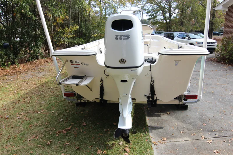 Slide: The Image of 2022 Carolina Skiff 19 LS boat with 115 HP outboard motor, parked outdoors. - 12
