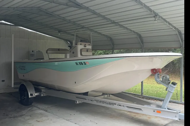 Slide: The Image of 2022 Carolina Skiff 19 LS boat interior with storage compartments and seating. - 4