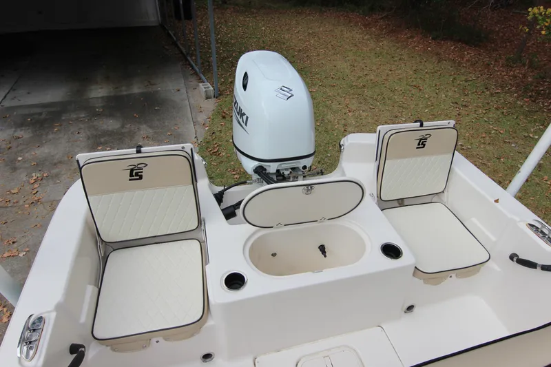 Slide: The Image of 2022 Carolina Skiff 19 LS boat interior with Suzuki outboard motor and seating. - 9