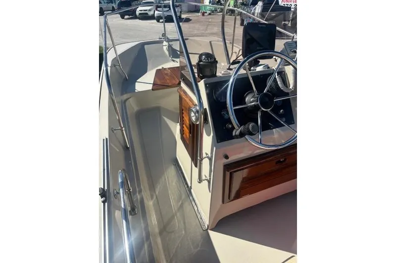 Slide: The Image of 1987 Boston Whaler 170 Montauk boat interior with steering wheel and control panel. - 4