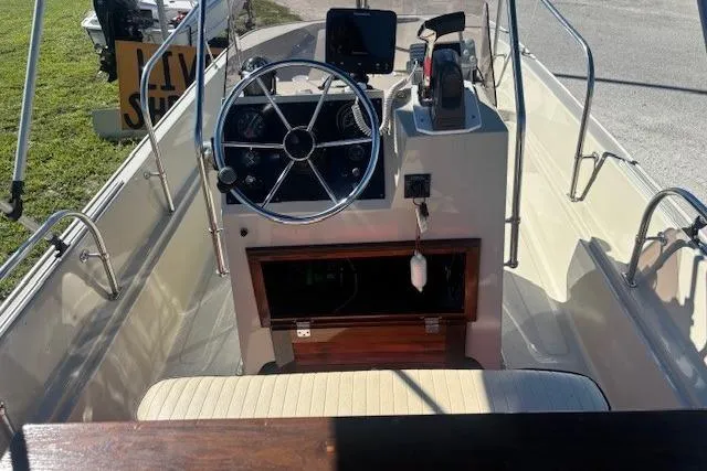 Slide: The Image of 1987 Boston Whaler 170 Montauk boat interior with steering wheel and control panel. - 6