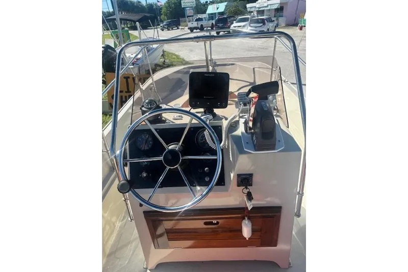 Slide: The Image of 1987 Boston Whaler 170 Montauk boat console with steering wheel and navigation equipment. - 7