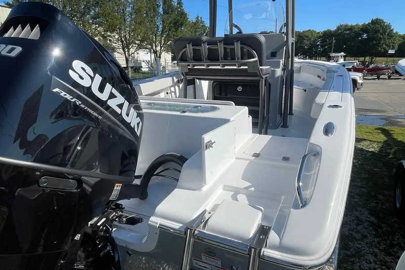 Slide: The Image of 2025 Sea Pro 222 Center Console boat with Suzuki four-stroke engine, docked outdoors. - 1