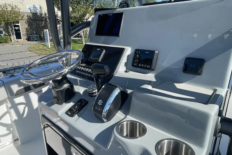 Slide: The Image of 2025 Sea Pro 222 Center Console boat dashboard with steering wheel and controls. - 5