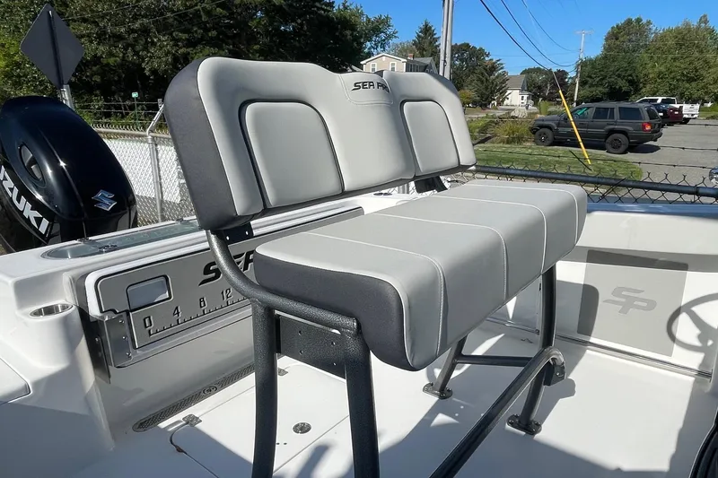 Slide: The Image of 2025 Sea Pro 222 Center Console boat with gray seating and Suzuki engine. - 6