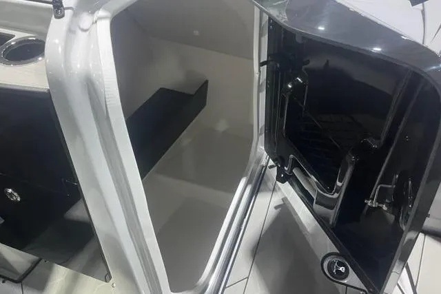 Slide: The Image of Interior storage compartment of 2025 Yamaha Boats 255XD, showcasing sleek design and functionality. - 3