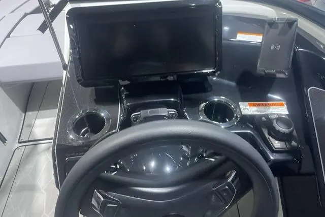 Slide: The Image of 2025 Yamaha Boats 255XD dashboard with steering wheel and touchscreen display. - 4