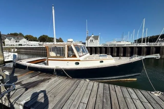 Slide: The Image of 1975 Jarvis Newman 32 DEC boat docked at a marina under clear blue skies. - 10