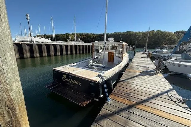 Slide: The Image of 1975 Jarvis Newman 32 DEC boat docked at a marina on a sunny day. - 11