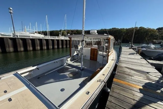 Slide: The Image of 1975 Jarvis Newman 32 DEC boat docked at a marina under clear blue skies. - 12