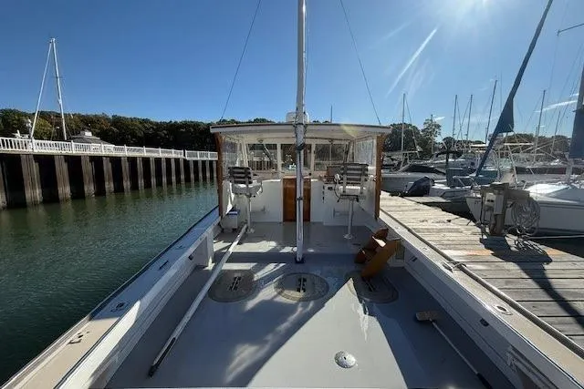 Slide: The Image of 1975 Jarvis Newman 32 DEC boat docked at a marina under clear blue skies. - 13