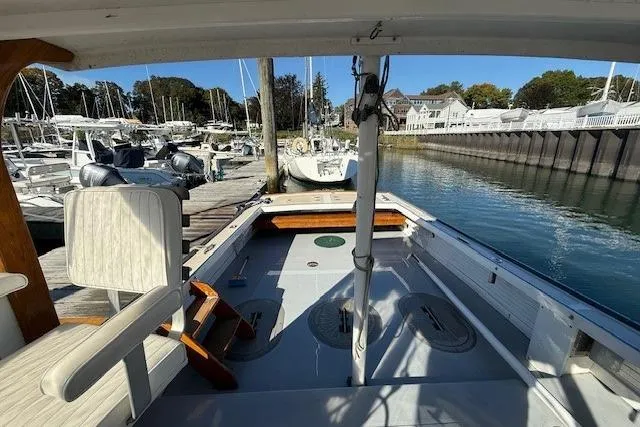 Slide: The Image of 1975 Jarvis Newman 32 DEC boat docked at a marina, showcasing spacious deck and seating. - 14