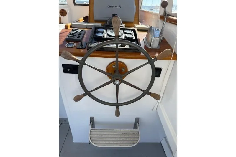 Slide: The Image of Vintage 1975 Jarvis Newman 32 DEC boat helm with wooden wheel and navigation equipment. - 15