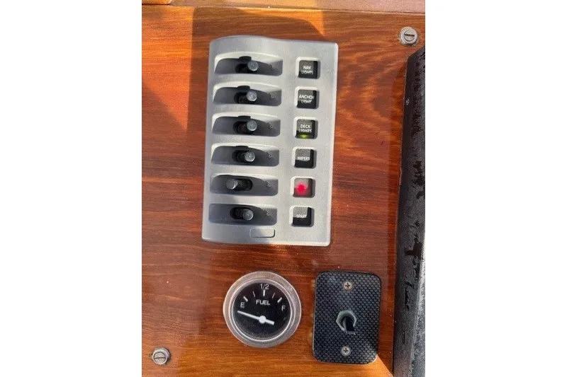 Slide: The Image of Control panel of a 1975 Jarvis Newman 32 DEC boat with switches and fuel gauge. - 17