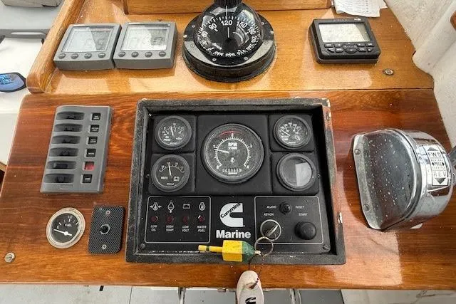 Slide: The Image of 1975 Jarvis Newman 32 DEC boat dashboard with gauges, compass, and control panel. - 22