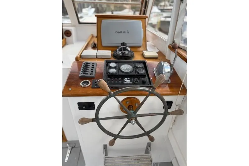 Slide: The Image of 1975 Jarvis Newman 32 DEC boat helm with Garmin navigation and classic steering wheel. - 23