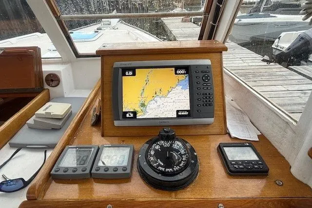 Slide: The Image of 1975 Jarvis Newman 32 DEC boat dashboard with navigation equipment and compass. - 24