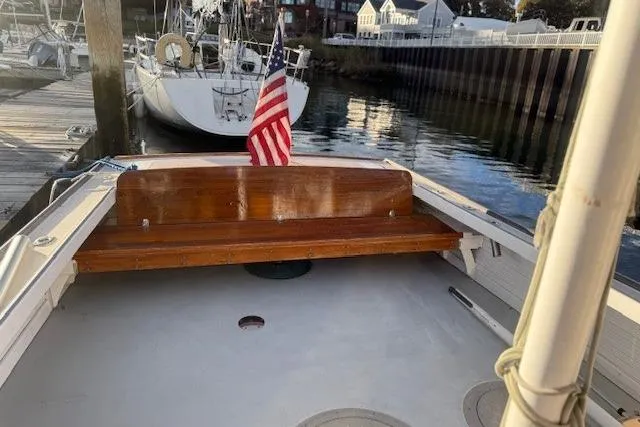 Slide: The Image of 1975 Jarvis Newman 32 DEC boat with American flag, docked in a marina. - 30