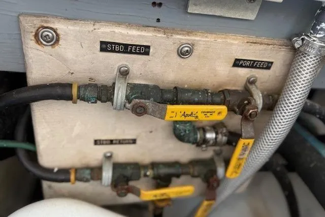 Slide: The Image of Control panel with labeled valves and hoses on a 1975 Jarvis Newman 32 DEC boat. - 32