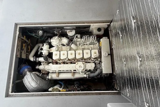 Slide: The Image of Engine compartment of a 1975 Jarvis Newman 32 DEC boat, showcasing detailed mechanical components. - 38