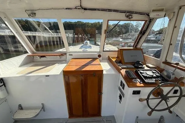 Slide: The Image of 1975 Jarvis Newman 32 DEC boat interior with wooden helm and navigation equipment. - 39