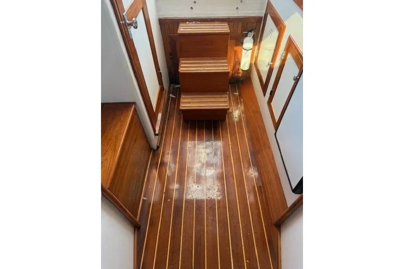 Slide: The Image of Interior of 1975 Jarvis Newman 32 DEC boat with wooden flooring and steps. - 41