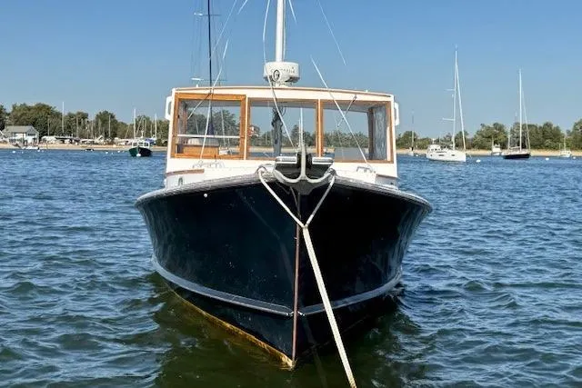 Slide: The Image of 1975 Jarvis Newman 32 DEC boat anchored on calm water with clear blue sky. - 5