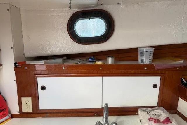 Slide: The Image of Interior of a 1975 Jarvis Newman 32 DEC boat with wooden cabinetry and porthole. - 51