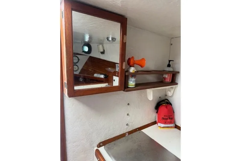 Slide: The Image of Interior of 1975 Jarvis Newman 32 DEC boat with mirror, shelves, and safety equipment. - 55