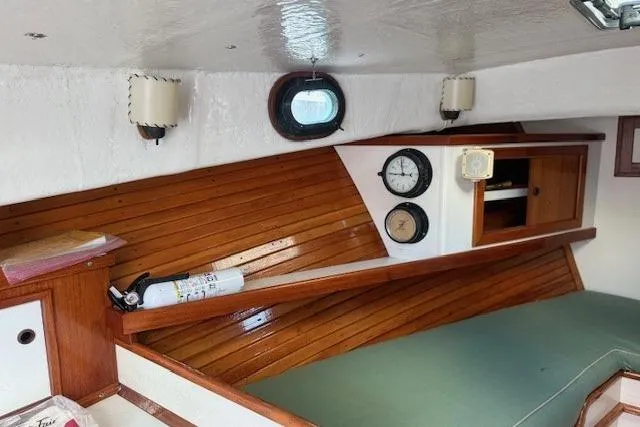 Slide: The Image of 1975 Jarvis Newman 32 DEC boat interior with wood paneling and nautical instruments. - 57