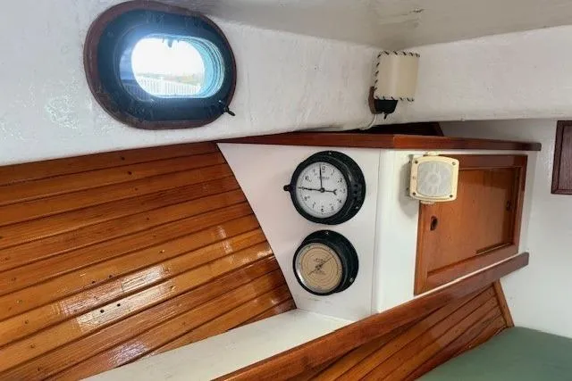 Slide: The Image of Interior of a 1975 Jarvis Newman 32 DEC boat with wooden paneling and nautical instruments. - 58