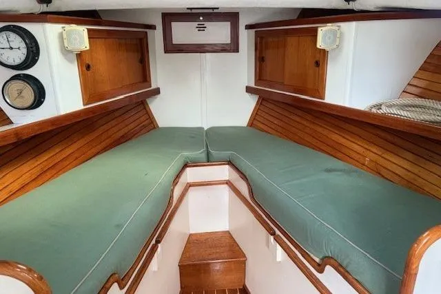 Slide: The Image of 1975 Jarvis Newman 32 DEC boat cabin with green cushions and wooden interior. - 59