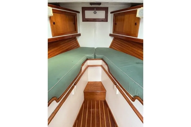 Slide: The Image of Interior of a 1975 Jarvis Newman 32 DEC boat with green cushions and wooden accents. - 61