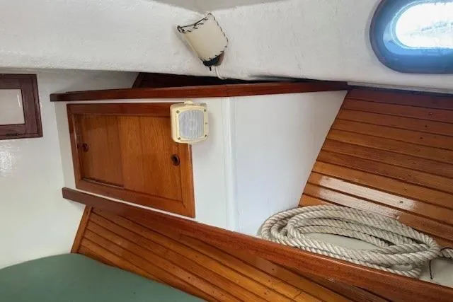 Slide: The Image of Interior of a 1975 Jarvis Newman 32 DEC boat with wooden paneling and rope. - 62
