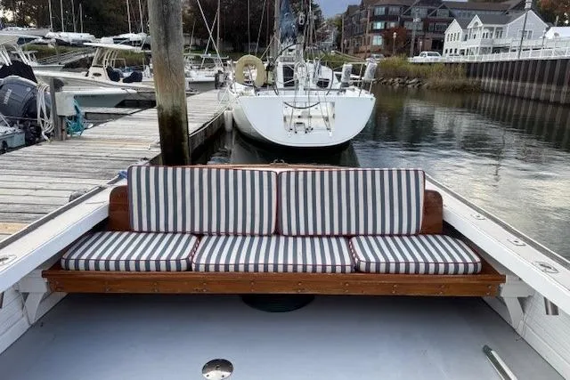 Slide: The Image of 1975 Jarvis Newman 32 DEC boat with striped seating at a marina dock. - 66