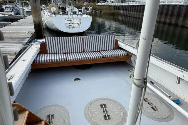 Slide: The Image of 1975 Jarvis Newman 32 DEC boat with striped seating at a marina dock. - 67
