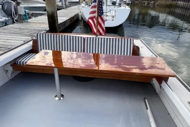 Slide: The Image of 1975 Jarvis Newman 32 DEC boat with striped seating and polished wooden table. - 69