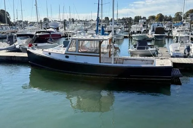 Slide: The Image of 1975 Jarvis Newman 32 DEC boat docked in a marina, surrounded by other vessels. - 7