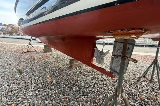 Slide: The Image of 1975 Jarvis Newman 32 DEC boat hull on gravel, supported by stands. - 74