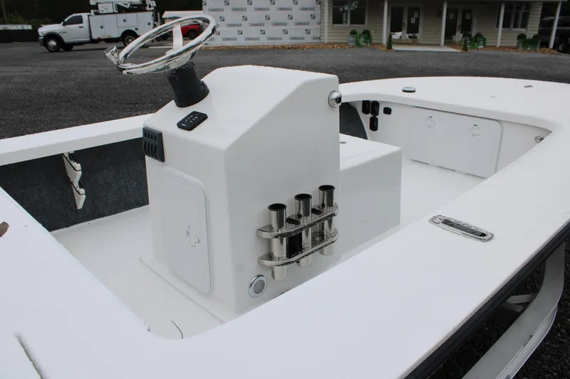 Slide: The Image of 2026 Mitzi Skiffs 17 Tournament boat interior with steering console and rod holders. - 5